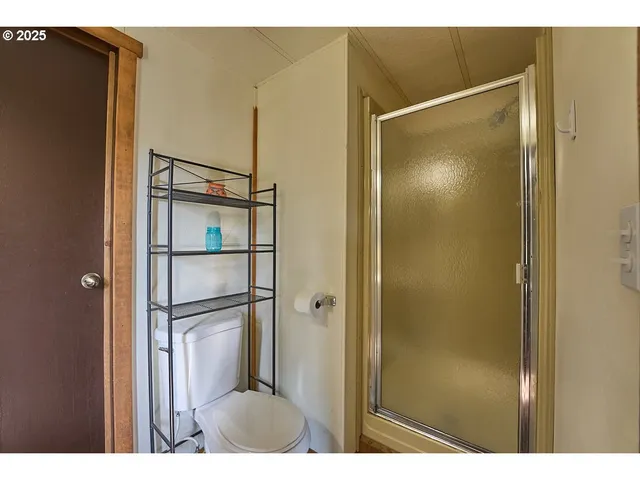 a bathroom with a glass shower door