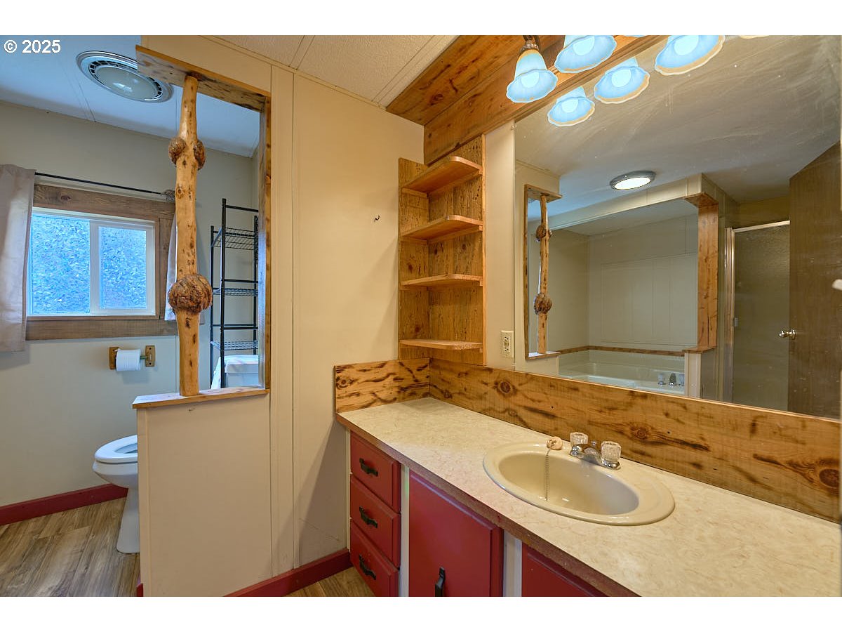 402 South East Street Joseph, OR 97846 - Photo 10 of 22 a bathroom with a granite countertop double vanity sink and a mirror