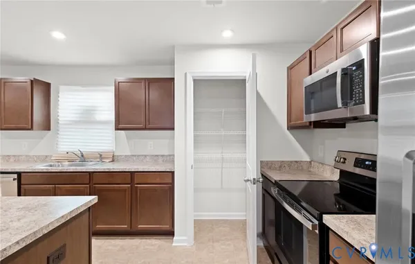 a kitchen with stainless steel appliances granite countertop a sink and a stove