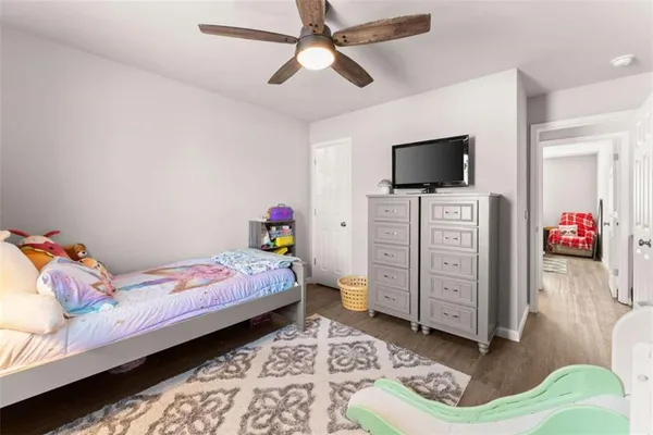 a bedroom with a bed and flat screen tv