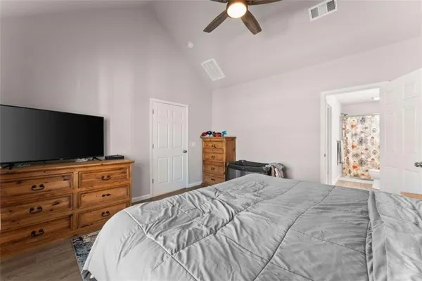 a bedroom with a bed and a flat screen tv