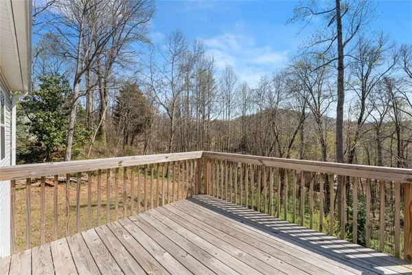 a balcony with wooden floor and fence