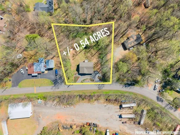 an aerial view of residential house and sandy dunes