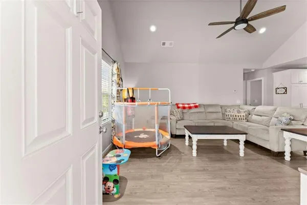 a living room with furniture and a wooden floor