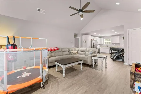 a living room with lots of furniture and a wooden floor