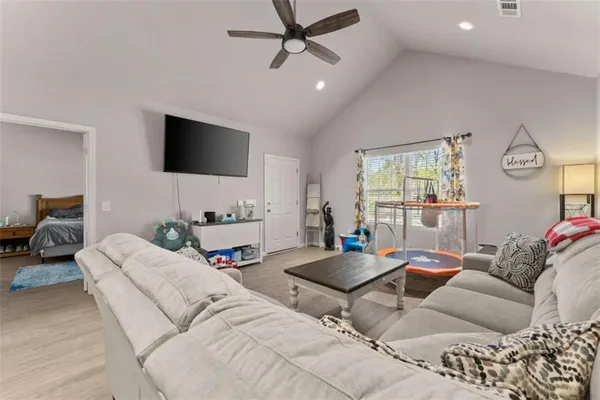 a living room with furniture and a flat screen tv