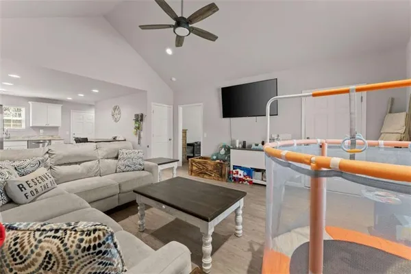 a living room with furniture and a flat screen tv