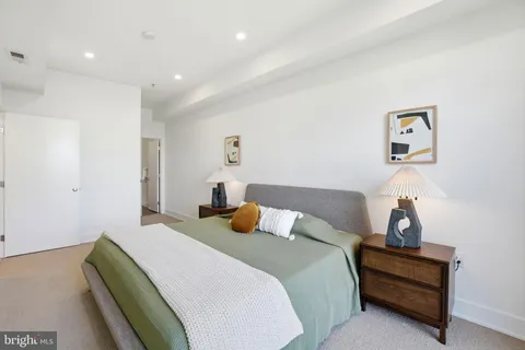 a bedroom with a bed and a lamp on table