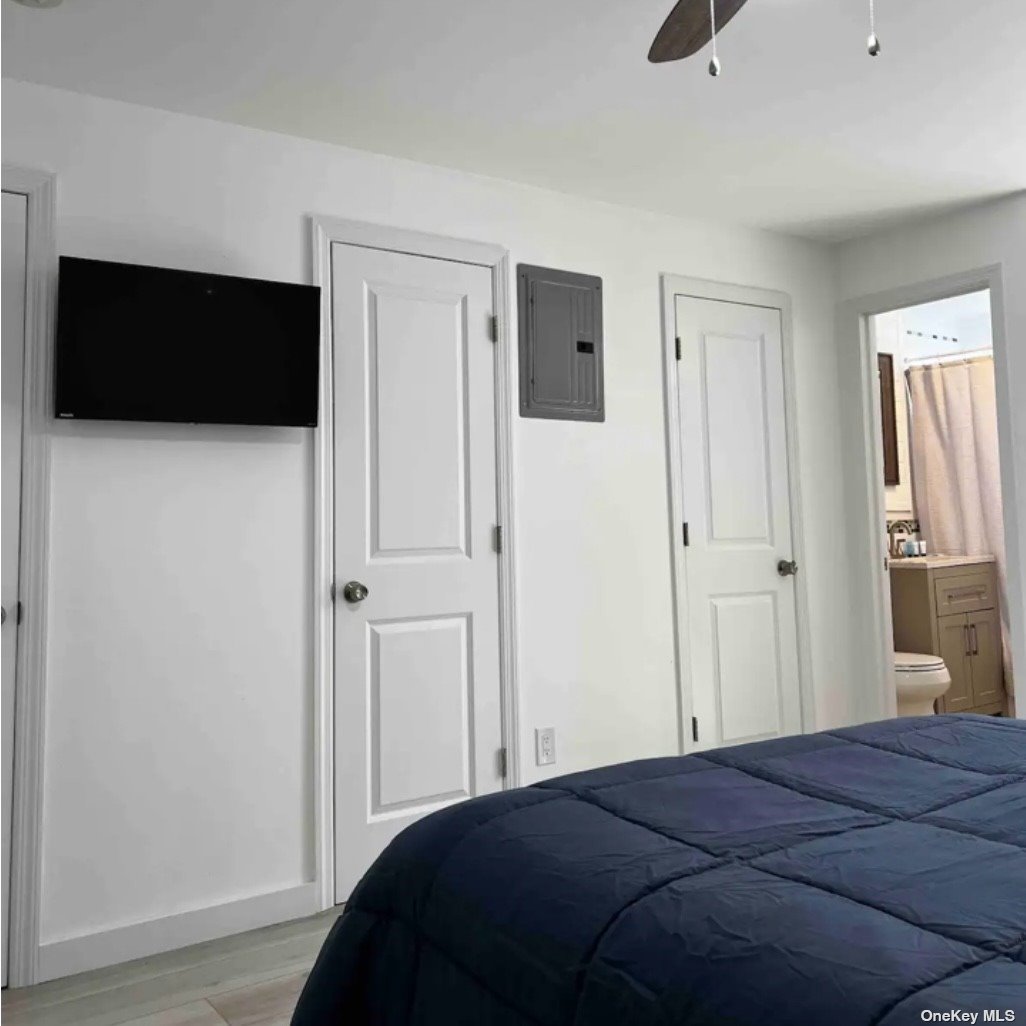 65 Long Beach, undefined 00000 - Photo 5 of 10 a bedroom with a bed and a flat screen tv