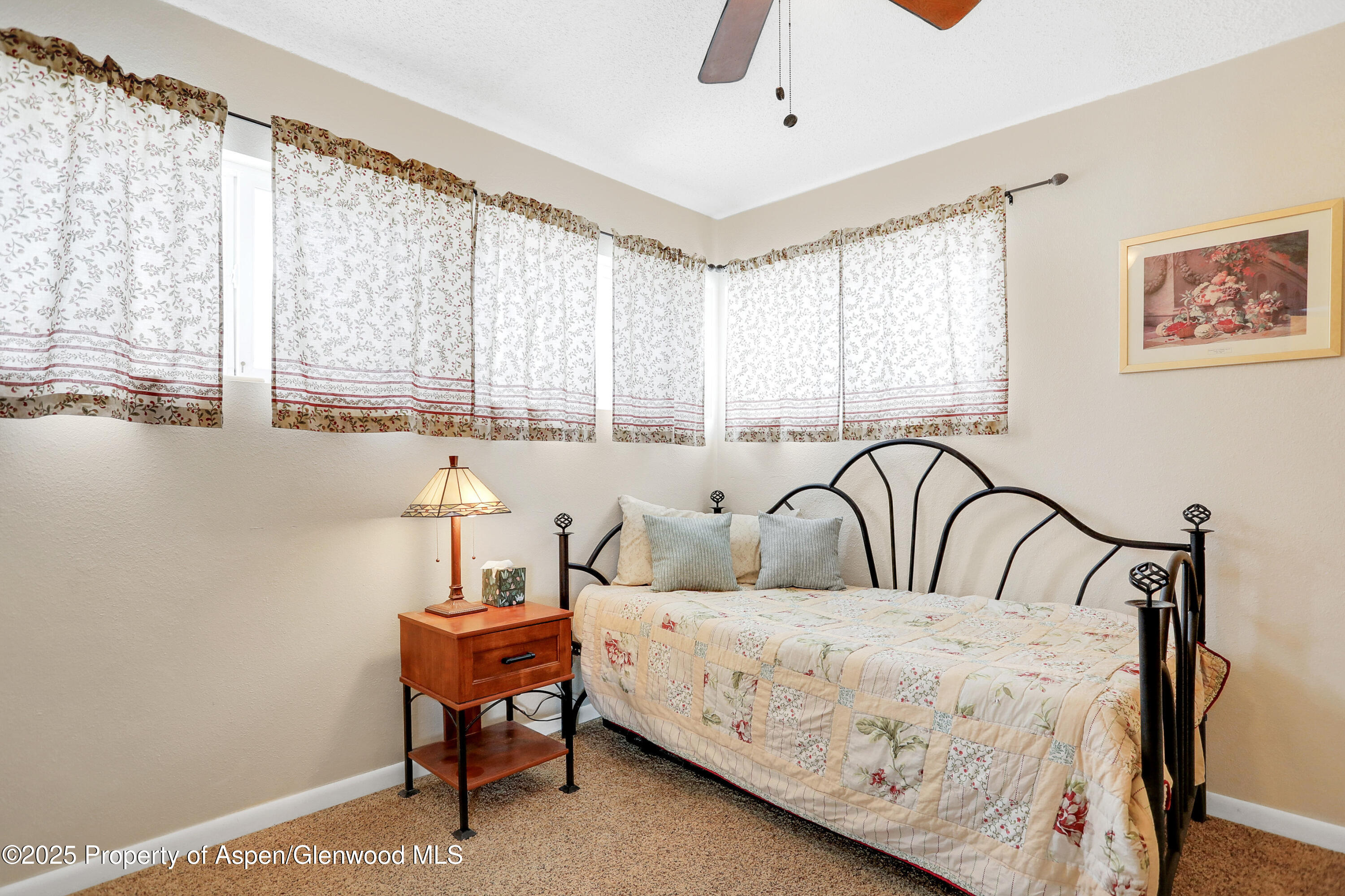 901 Pershing Street Craig, CO 81625 - Photo 13 of 37 a bedroom with furniture and a large window