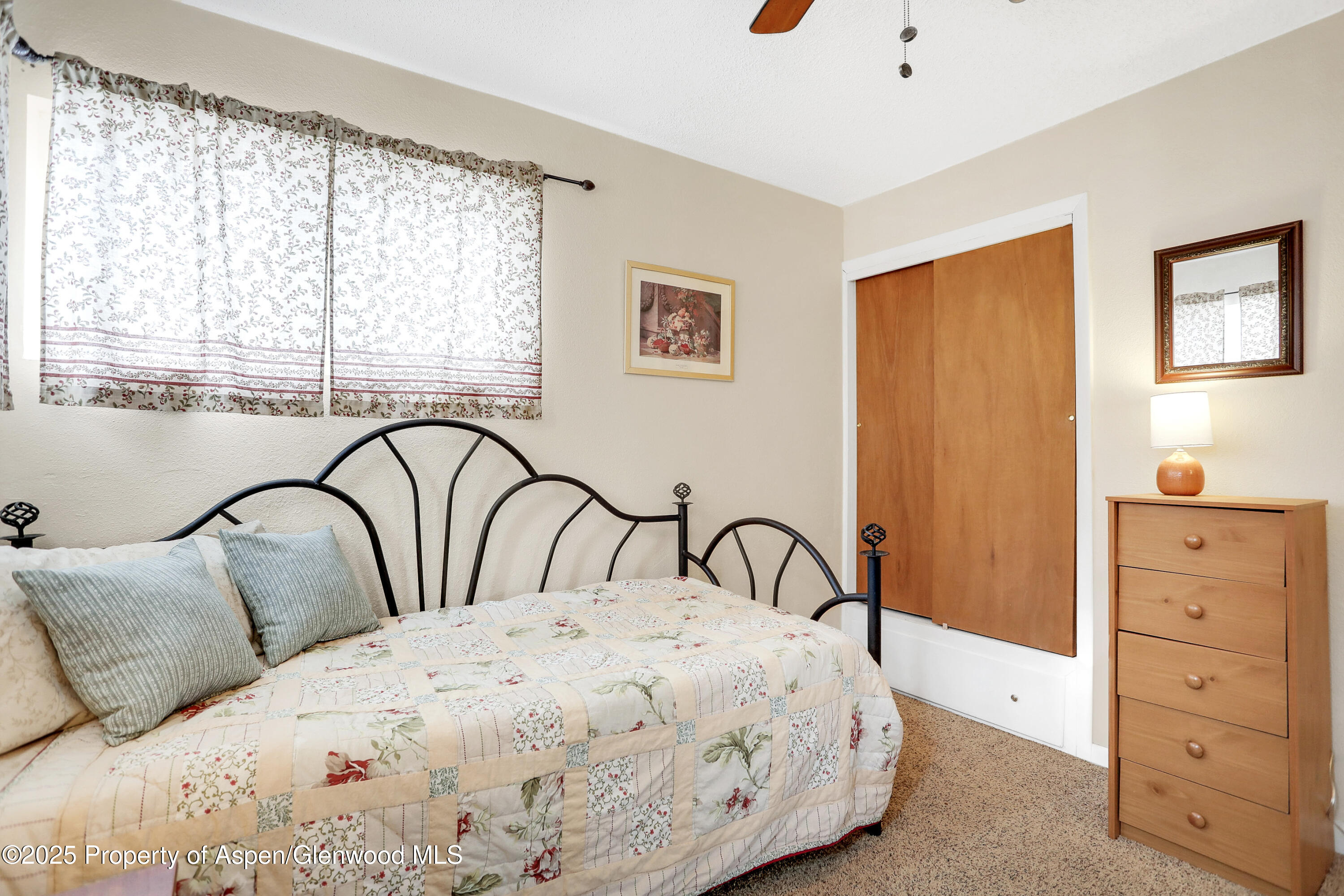 901 Pershing Street Craig, CO 81625 - Photo 14 of 37 a bedroom with a bed and a dresser