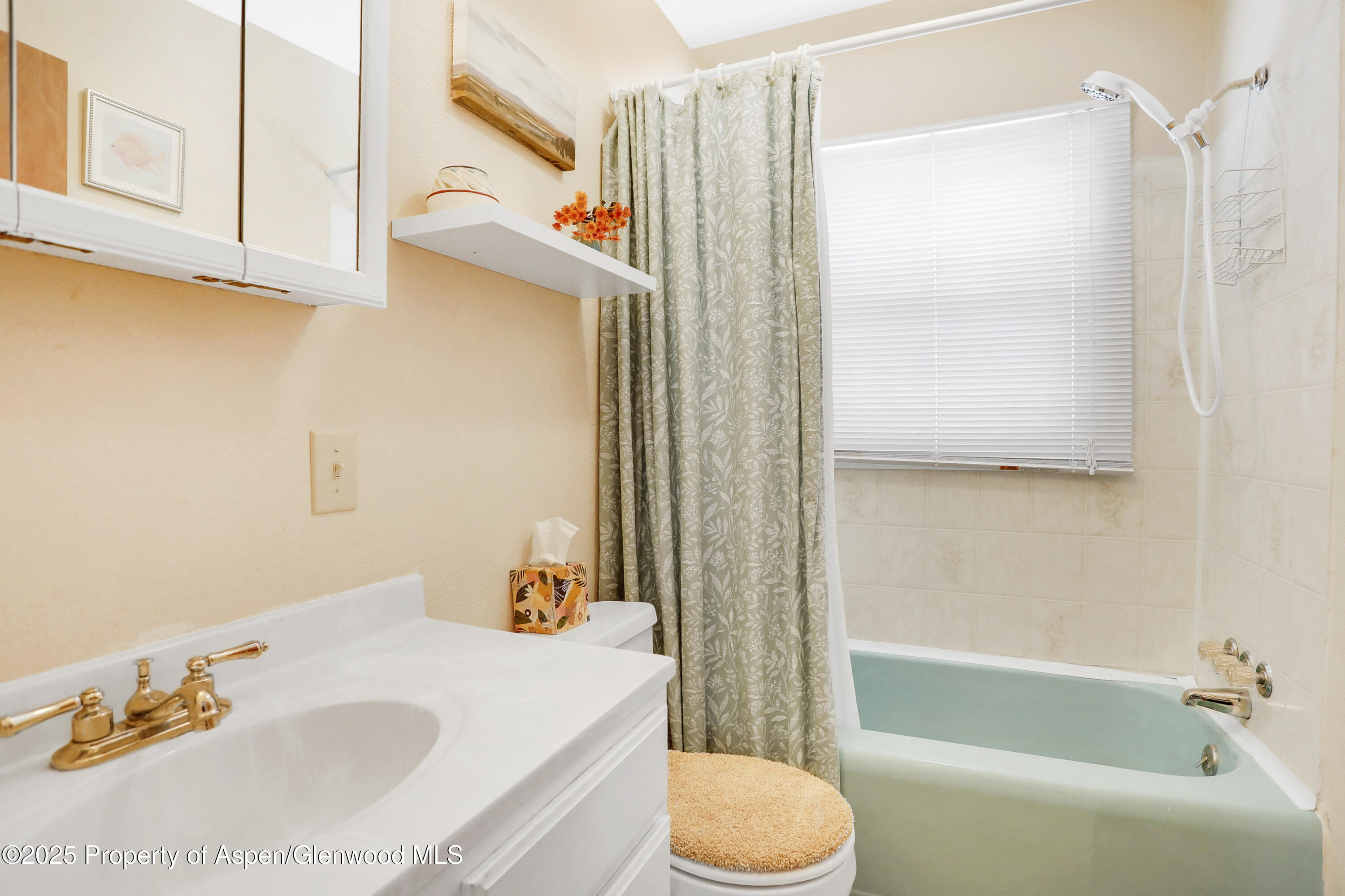 901 Pershing Street Craig, CO 81625 - Photo 17 of 37 a bathroom with a sink toilet and shower