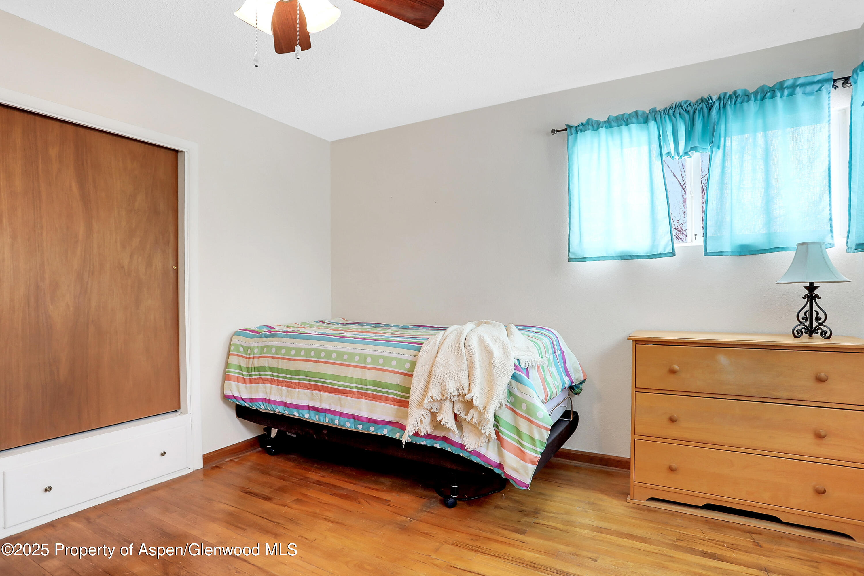 901 Pershing Street Craig, CO 81625 - Photo 19 of 37 a bedroom with a bed and a window