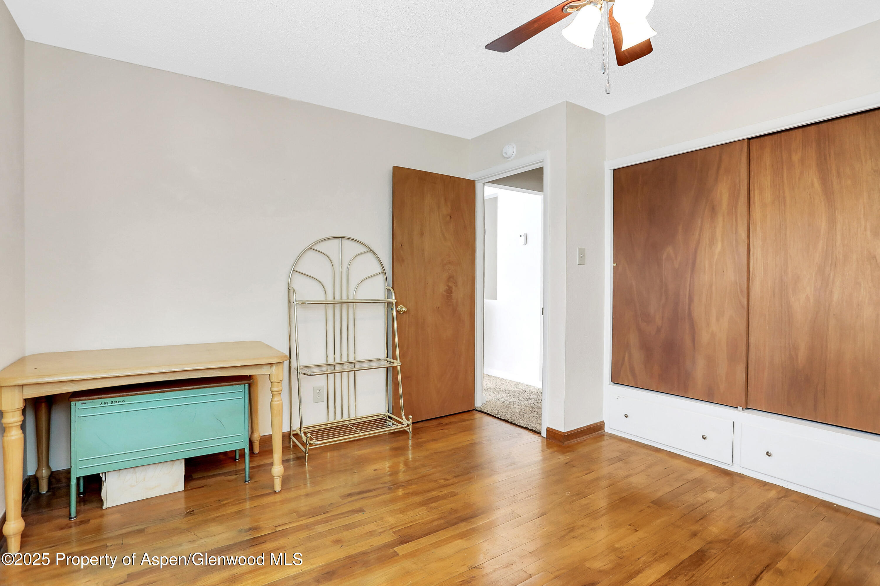 901 Pershing Street Craig, CO 81625 - Photo 20 of 37 a view of empty room with wooden floor and window