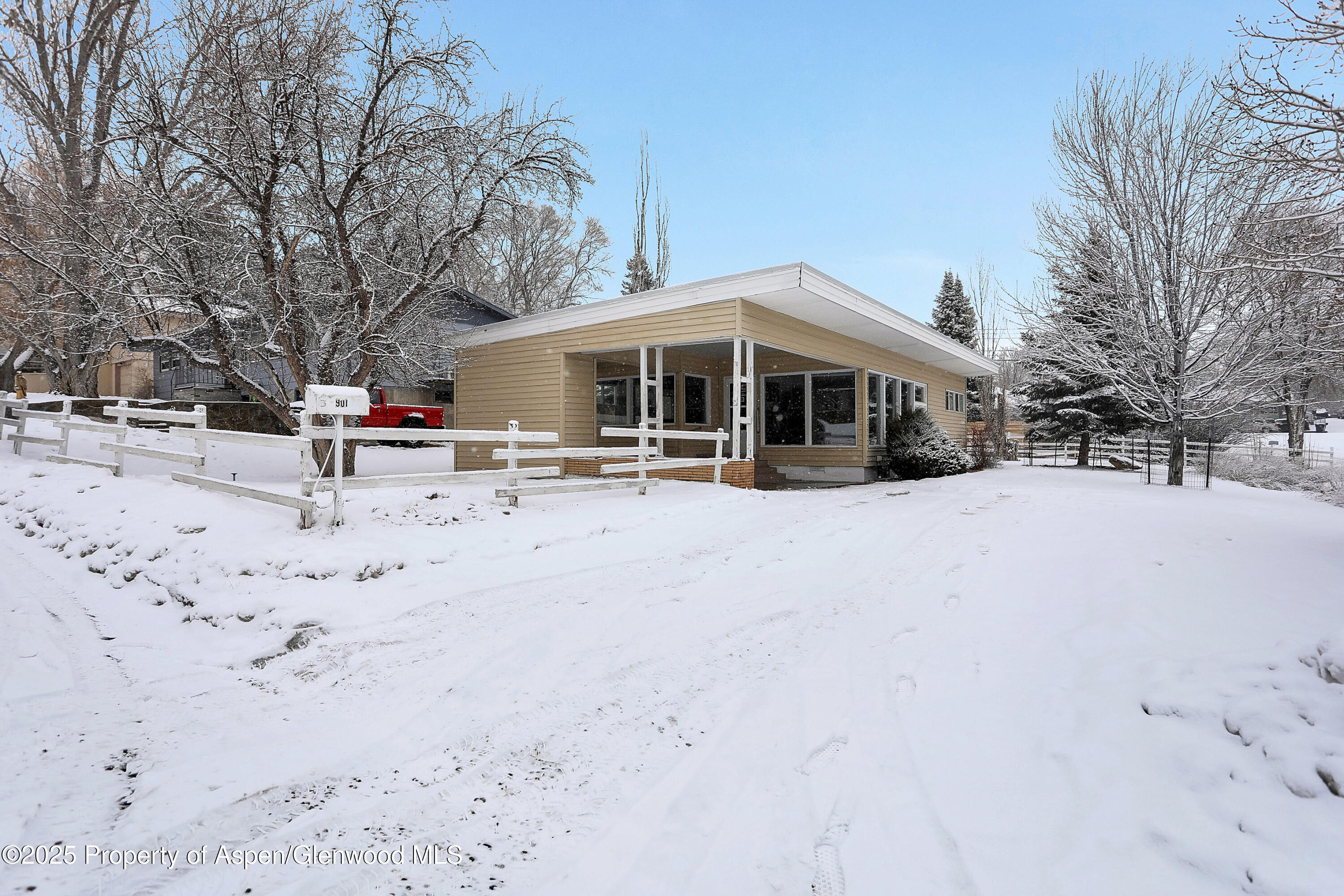 901 Pershing Street Craig, CO 81625 - Photo 2 of 37 a view of the house with a snow on the road