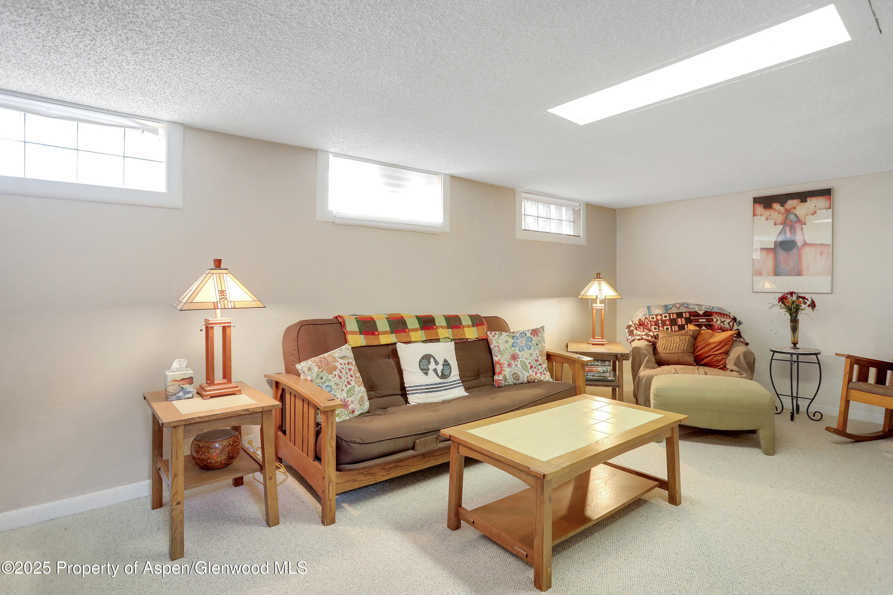 901 Pershing Street Craig, CO 81625 - Photo 21 of 37 a living room with furniture a lamp and a window