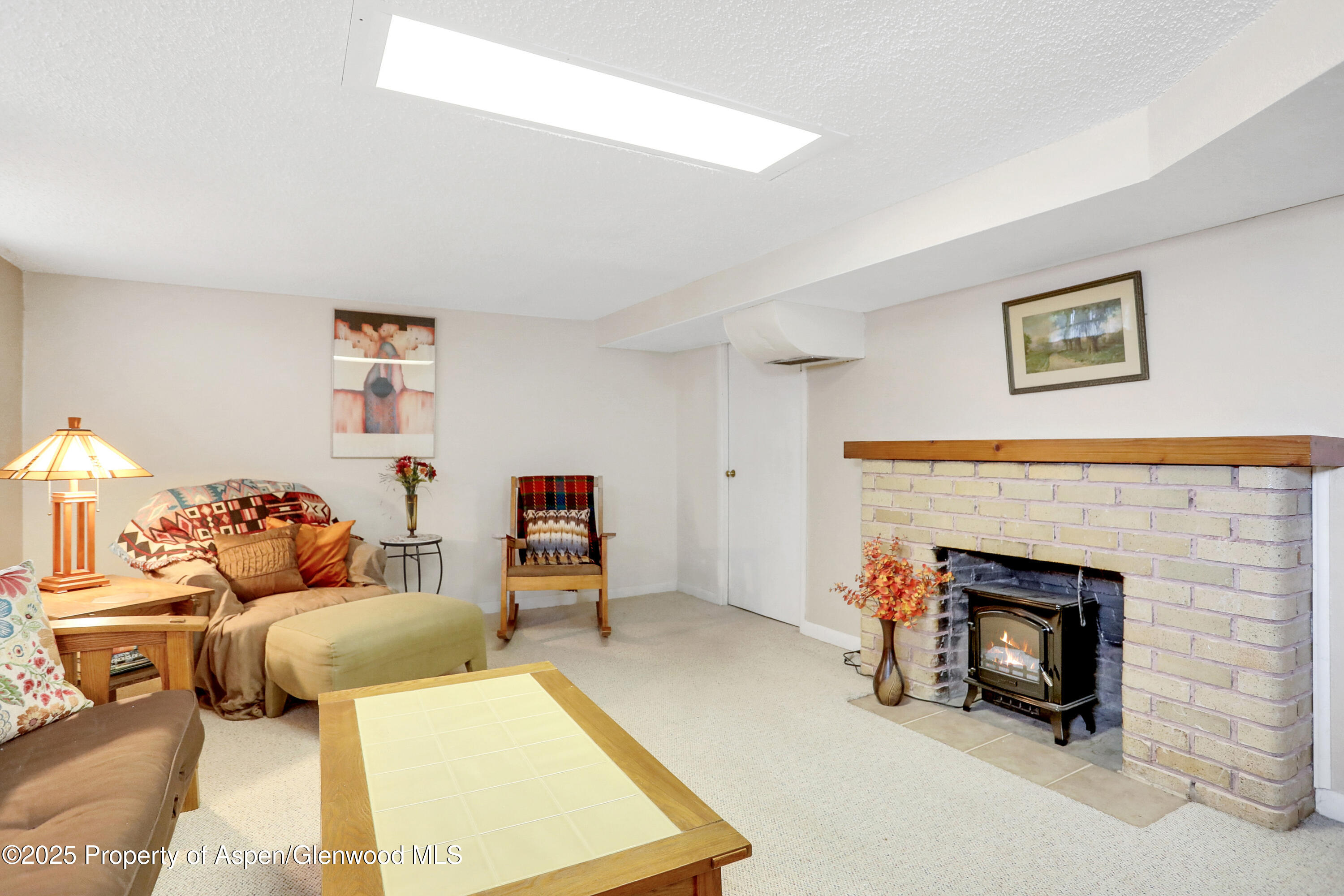901 Pershing Street Craig, CO 81625 - Photo 23 of 37 a living room with furniture and a fireplace