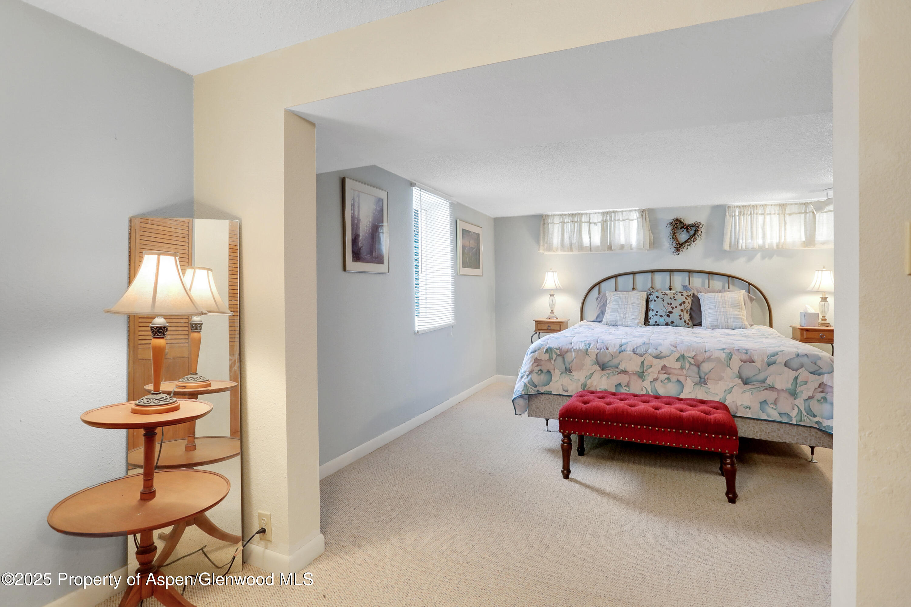 901 Pershing Street Craig, CO 81625 - Photo 26 of 37 a bedroom with furniture and a lamp