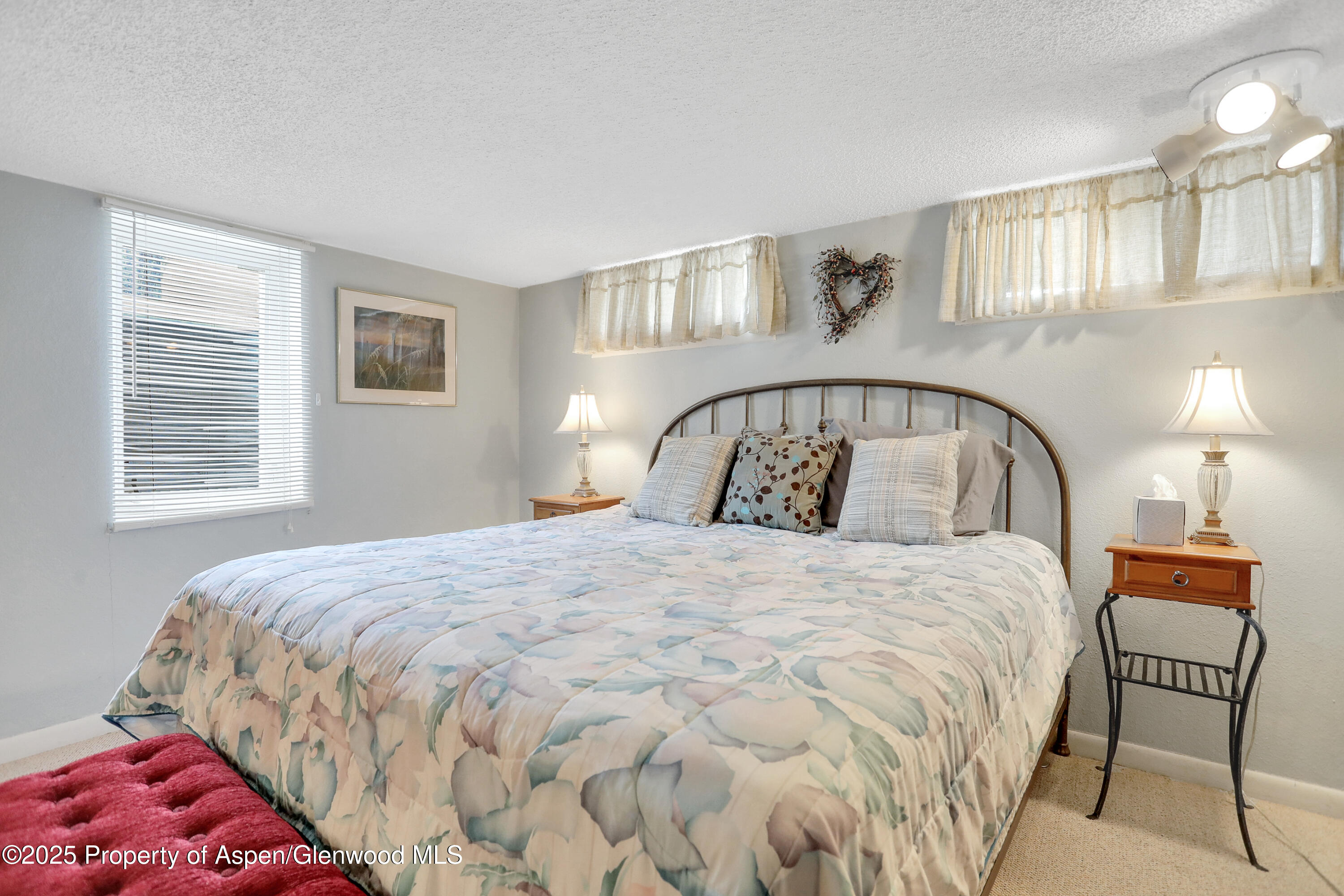 901 Pershing Street Craig, CO 81625 - Photo 27 of 37 a bedroom with a bed and a mirror