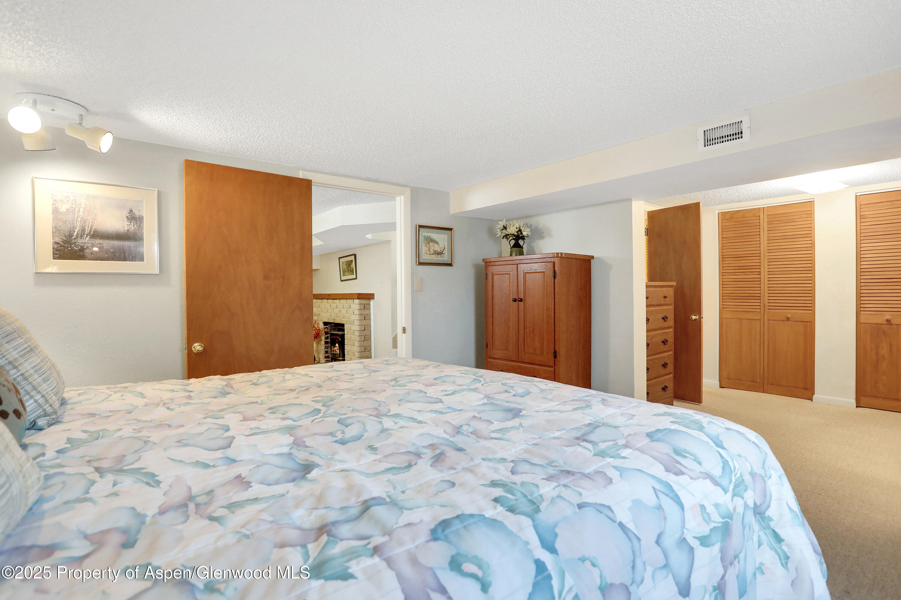 901 Pershing Street Craig, CO 81625 - Photo 28 of 37 a bedroom with a large bed and wooden floor