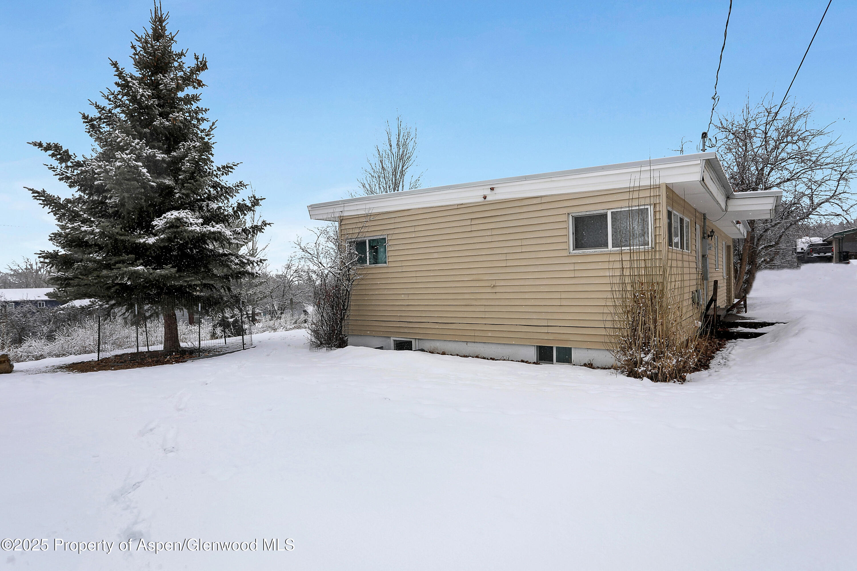 901 Pershing Street Craig, CO 81625 - Photo 32 of 37 a view of a house with a yard