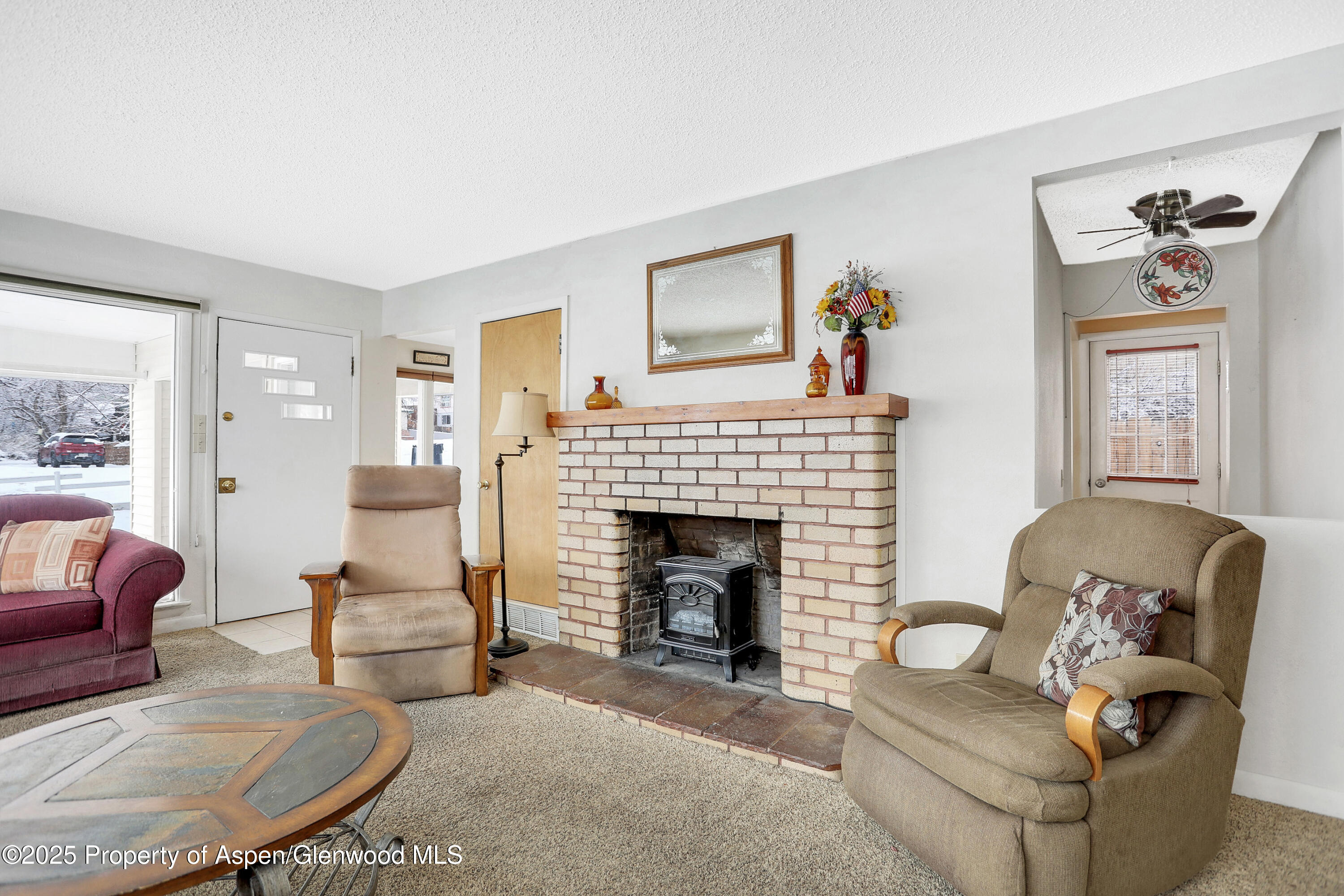 901 Pershing Street Craig, CO 81625 - Photo 5 of 37 a living room with furniture and a fireplace