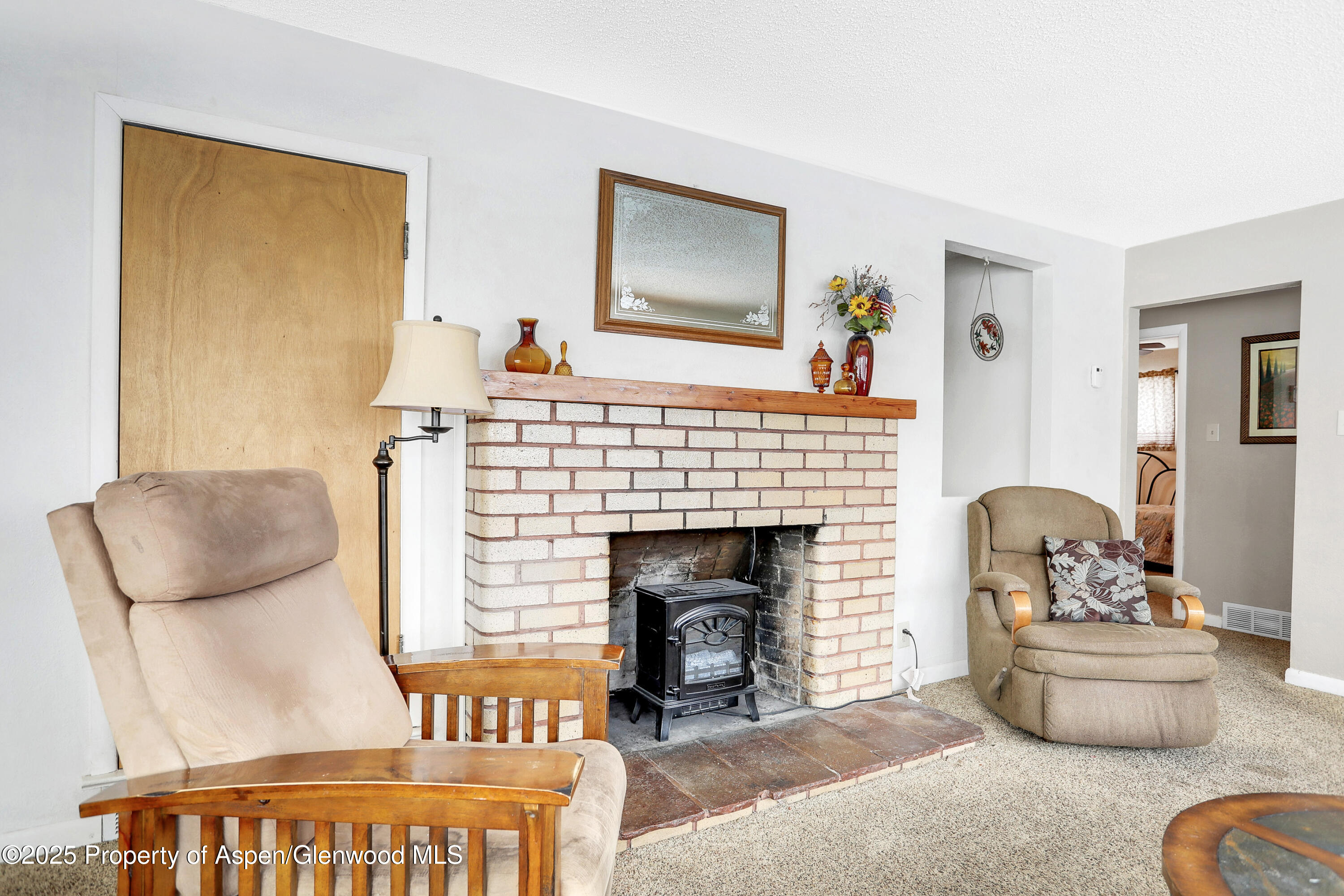 901 Pershing Street Craig, CO 81625 - Photo 6 of 37 a living room with furniture and a fireplace