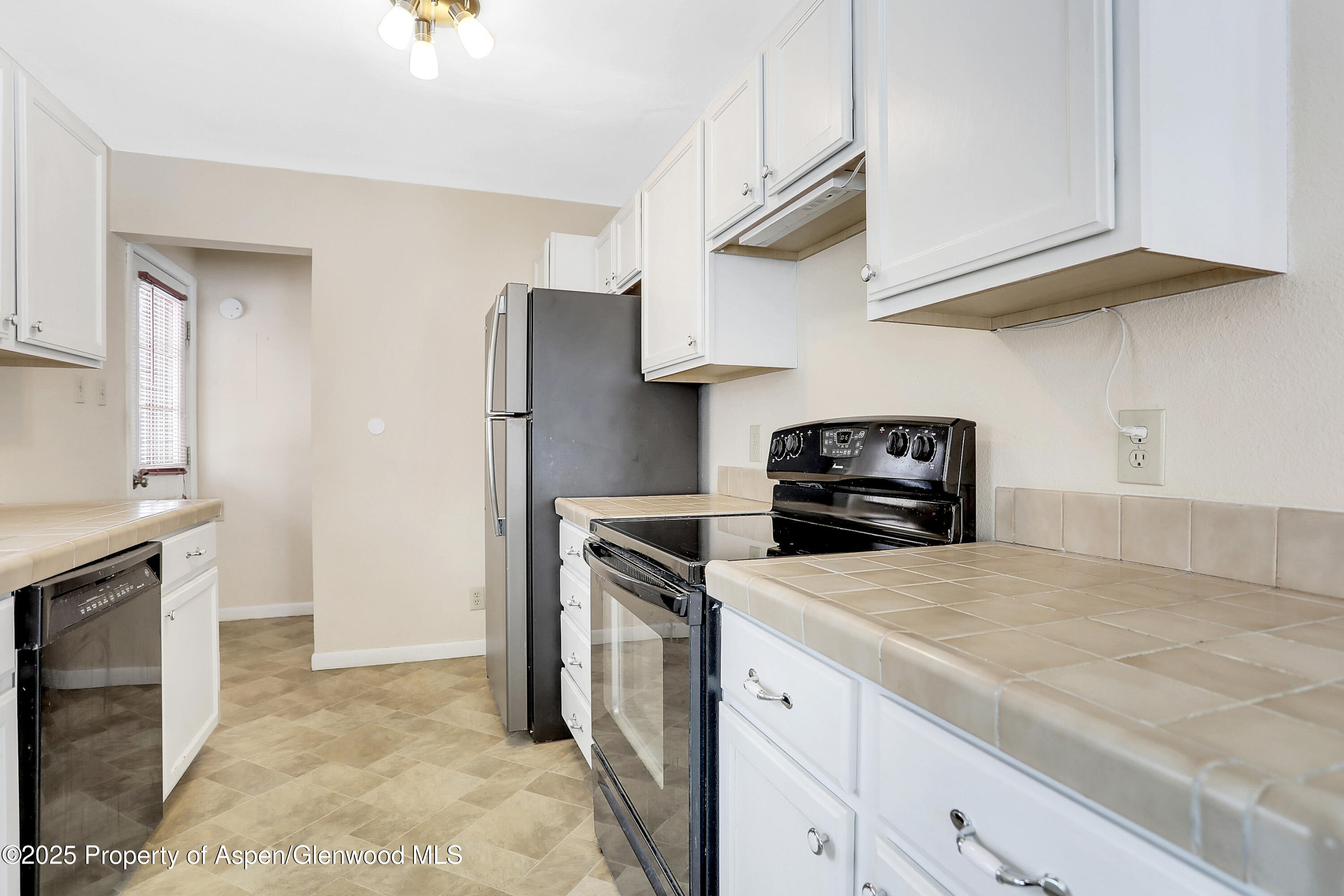 901 Pershing Street Craig, CO 81625 - Photo 9 of 37 a kitchen with a refrigerator and a stove