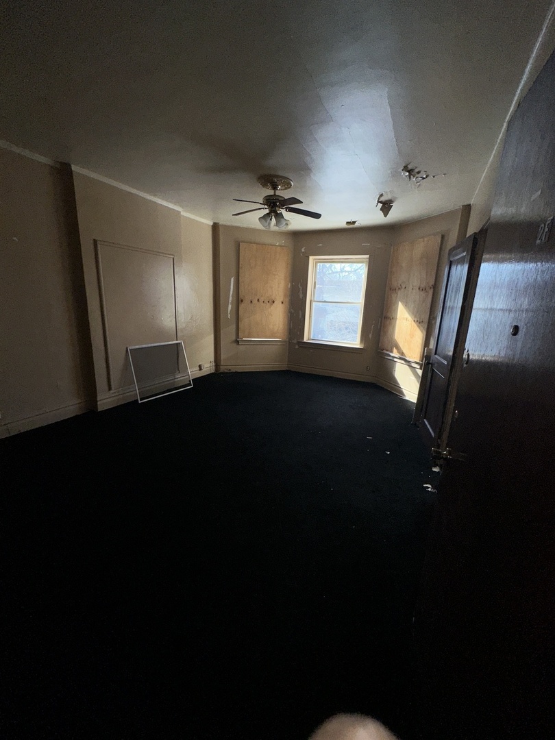 7425 South Harvard Avenue Chicago, IL 60621 - Photo 12 of 31 a view of an empty room with a window
