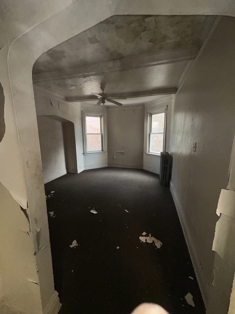 7425 South Harvard Avenue Chicago, IL 60621 - Photo 5 of 31 a view of livingroom with window and hardwood floor