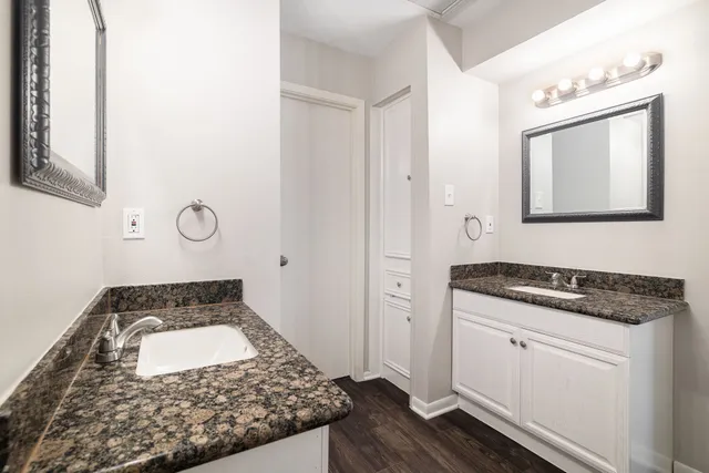 a kitchen with white cabinets and a stove