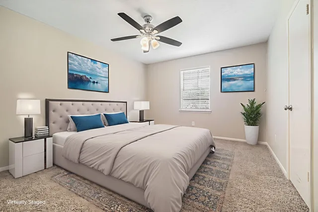 a bedroom with a large bed and a window