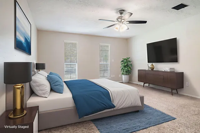 a bedroom with a bed and a flat screen tv