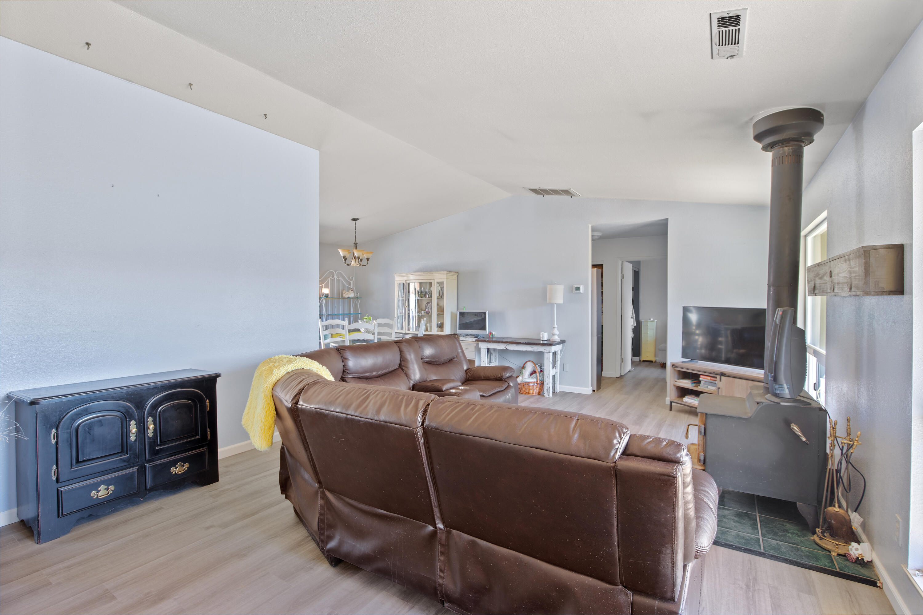 12748 Water Gap Road Williams, OR 97544 - Photo 11 of 35 a living room with furniture a flat screen tv and a fireplace