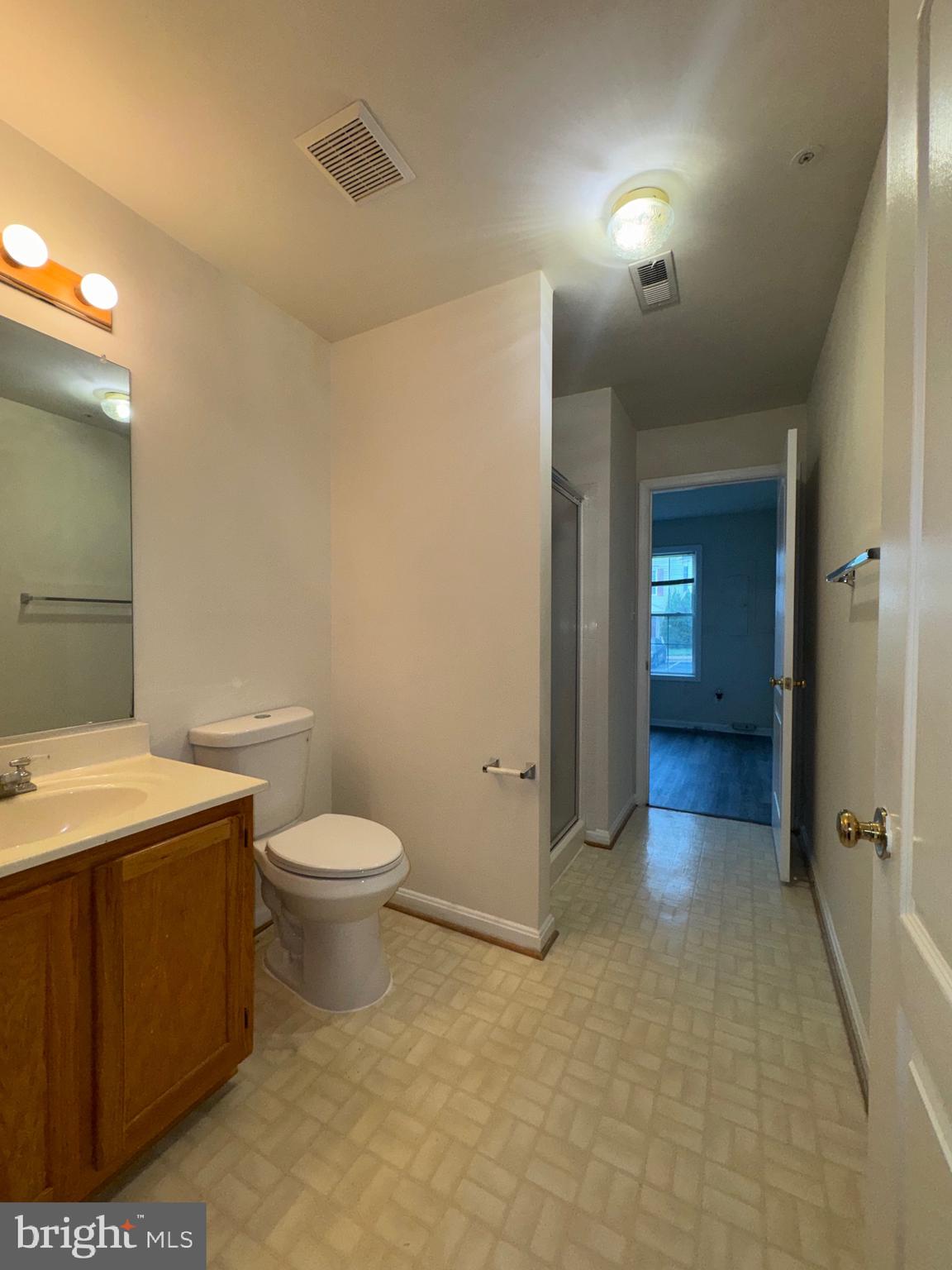 7705 Periwinkle Way, Unit 71 Severn, MD 21144 - Photo 7 of 28 a bathroom with a toilet a sink and shower