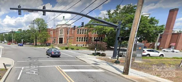 a view of backyard with large trees