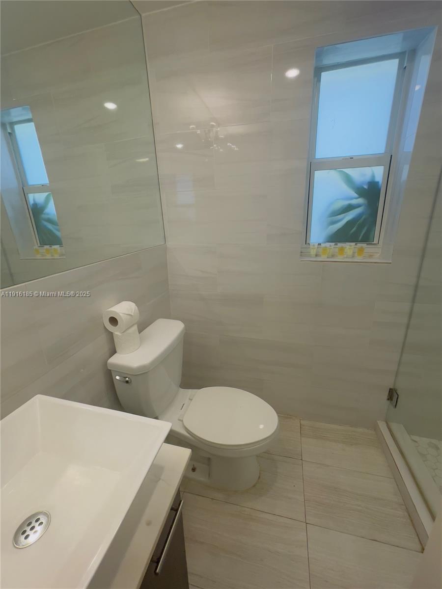 7710 Harding Avenue, Unit 403 Miami Beach, FL 33141 - Photo 7 of 7 a bathroom with a toilet and a sink