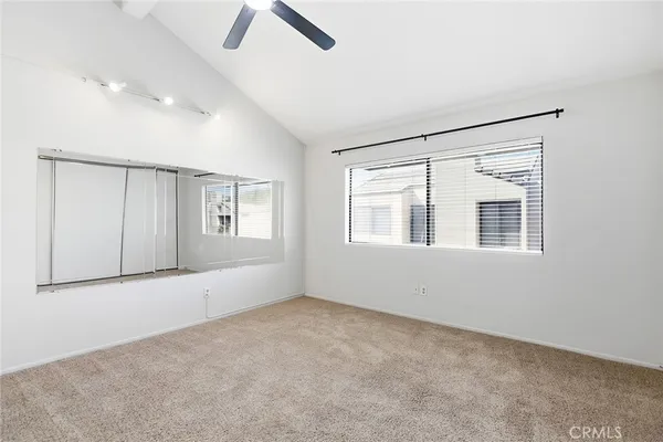an empty room with windows and closet