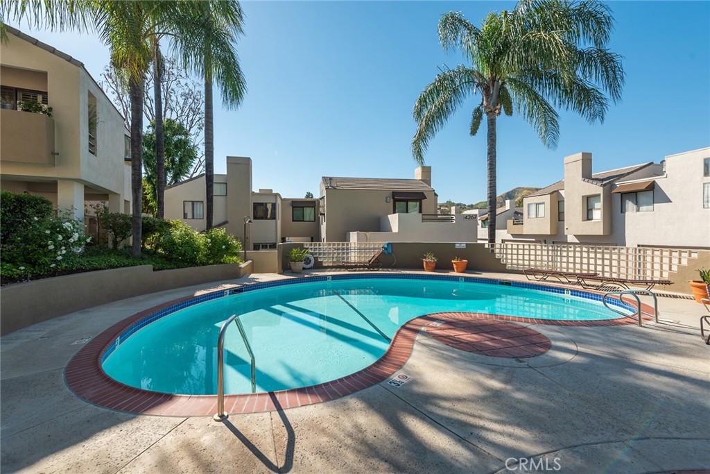 4265 Las Virgenes Road, Unit 2 Calabasas, CA 91302 - Photo 25 of 26 a swimming pool with outdoor seating and yard