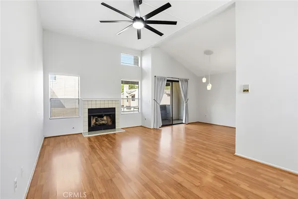 a view of empty room with fireplace and wooden floor