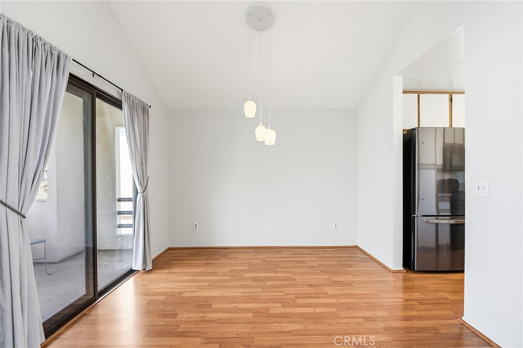 4265 Las Virgenes Road, Unit 2 Calabasas, CA 91302 - Photo 9 of 26 a view of empty room with wooden floor and window