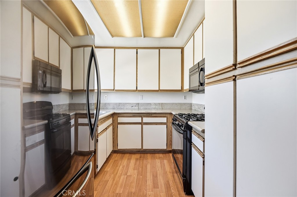 4265 Las Virgenes Road, Unit 2 Calabasas, CA 91302 - Photo 10 of 26 a kitchen with stainless steel appliances granite countertop a stove a sink and a refrigerator
