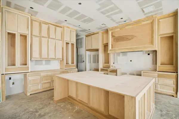 a kitchen with a stove a sink and a refrigerator