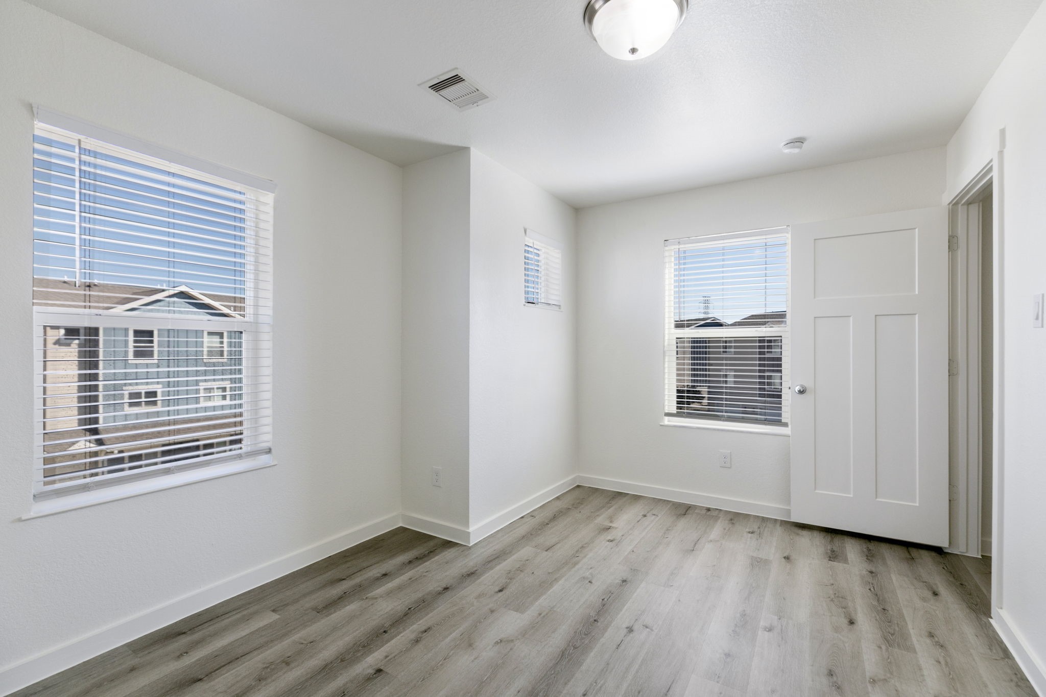 21155 Gosling Road, Unit 11A Spring, TX 77388 - Photo 15 of 27 a view of an empty room with wooden floor and a window