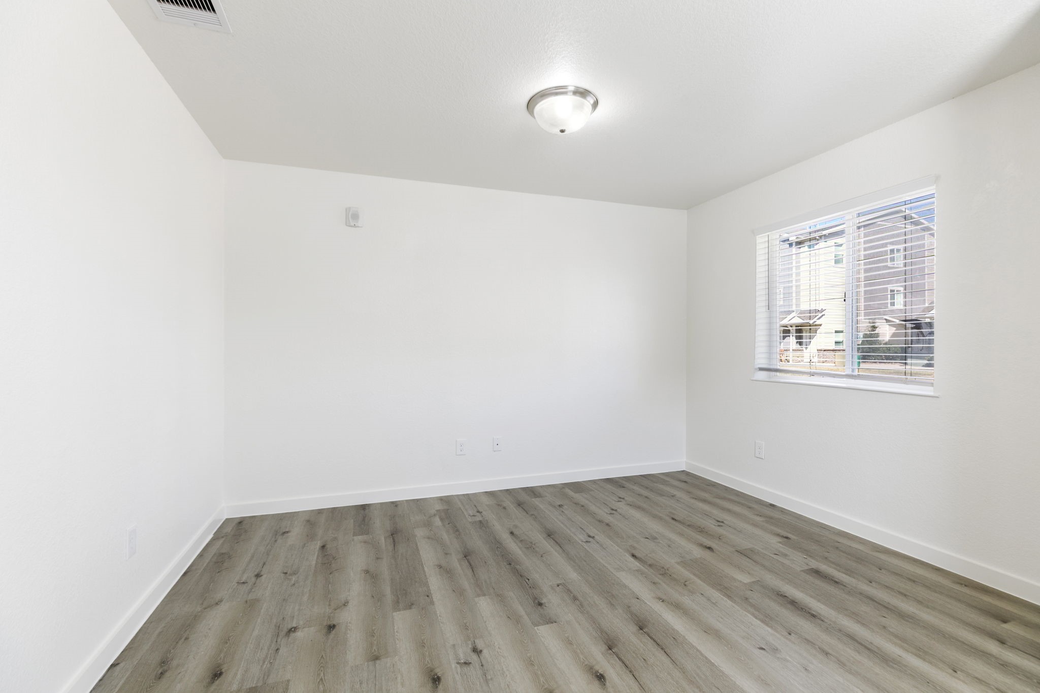 21155 Gosling Road, Unit 11A Spring, TX 77388 - Photo 5 of 27 an empty room with wooden floor and windows