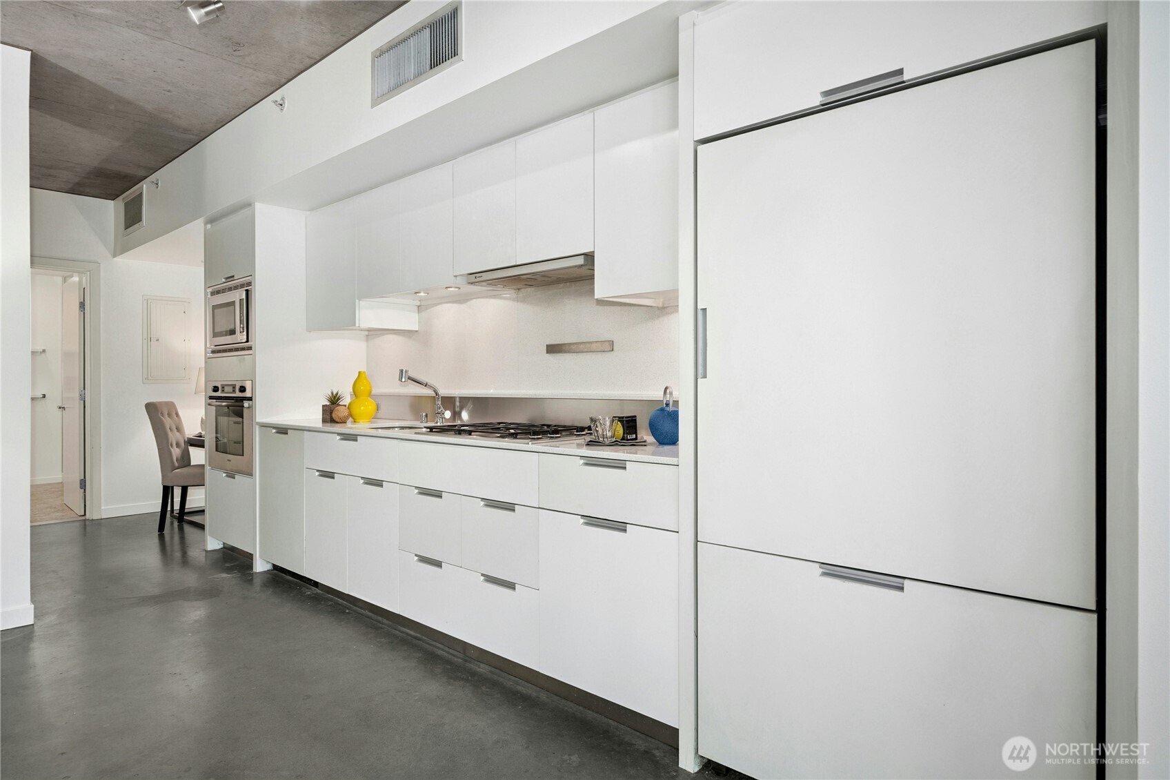 501 Roy Street, Unit F239 Seattle, WA 98109 - Photo 11 of 27 a kitchen with stainless steel appliances a refrigerator and a cabinets