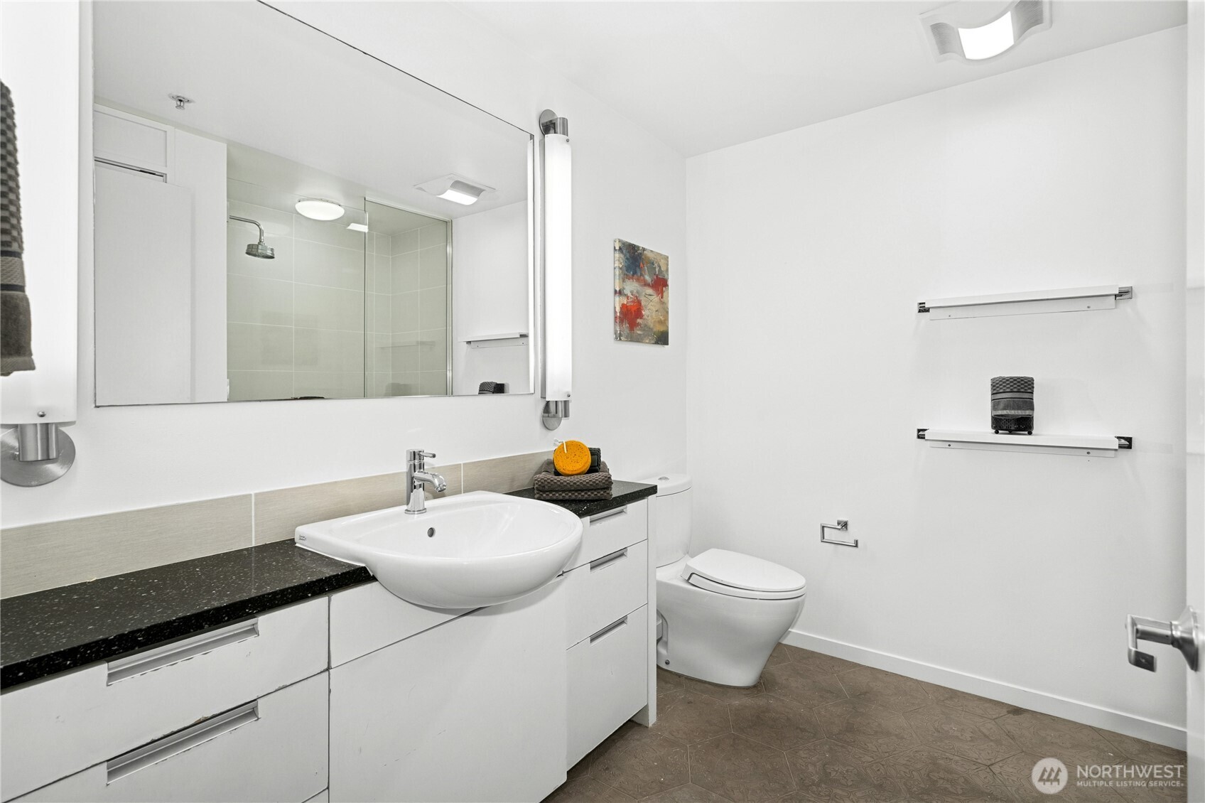501 Roy Street, Unit F239 Seattle, WA 98109 - Photo 19 of 27 a bathroom with a sink toilet and a mirror