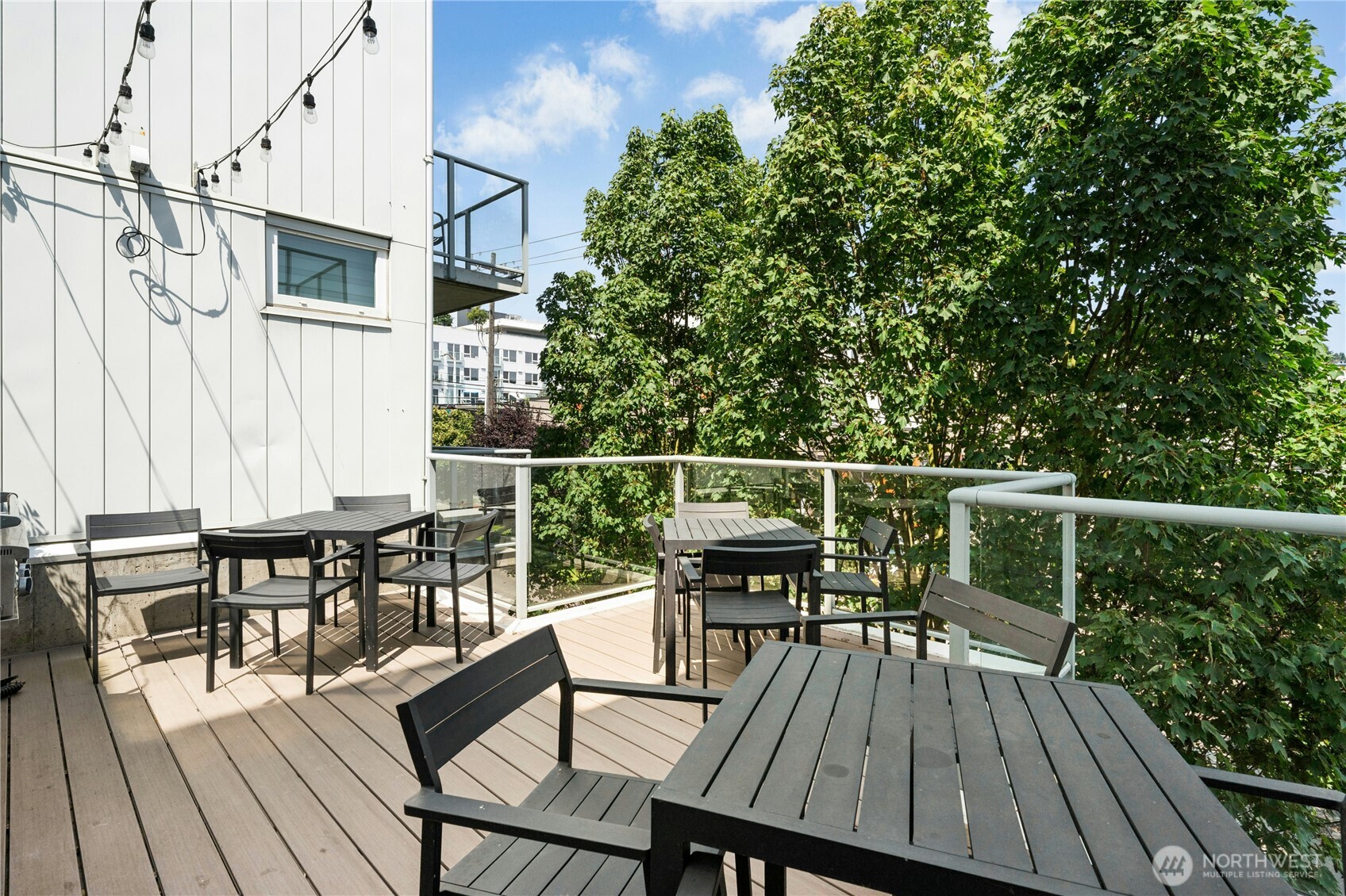 501 Roy Street, Unit F239 Seattle, WA 98109 - Photo 27 of 27 a view of a roof deck with table and chairs