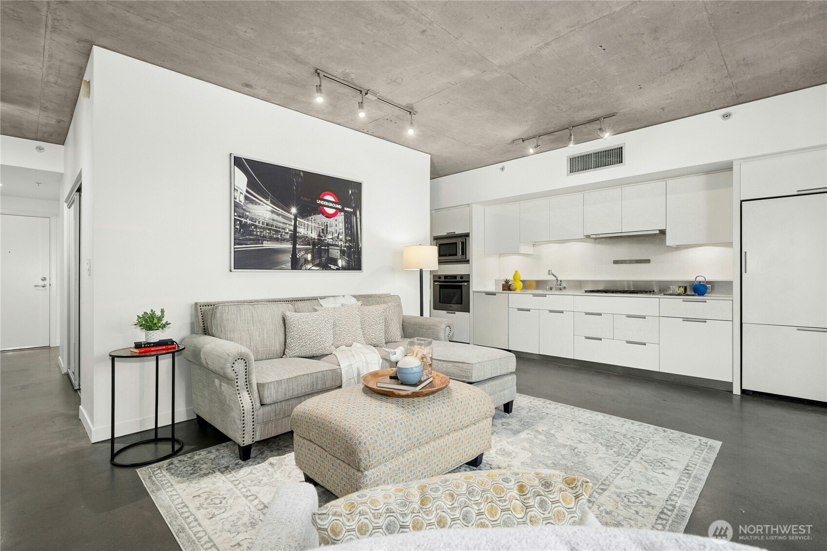 501 Roy Street, Unit F239 Seattle, WA 98109 - Photo 6 of 27 a living room with furniture and kitchen view