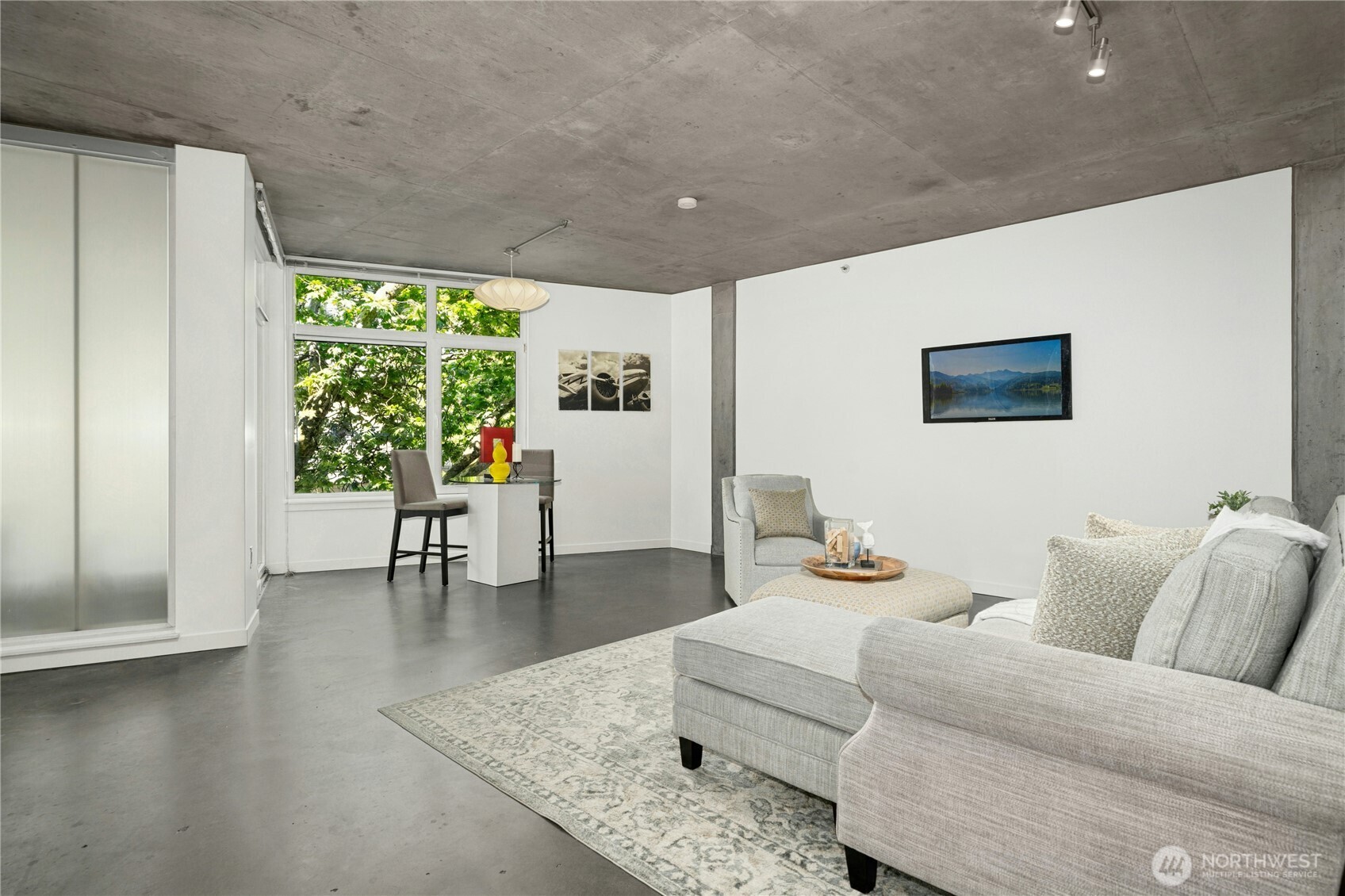 501 Roy Street, Unit F239 Seattle, WA 98109 - Photo 8 of 27 a living room with furniture and a large window
